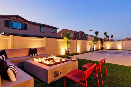 a backyard with a couch and a fire pit at 7BR Pickleball Firepit Outdoor Kitchen Game Room in Coachella