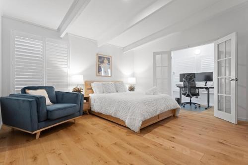a bedroom with a bed and a chair and a desk at The Bay Haus - Luxury Escape so close to the Beach in Worrowing Heights