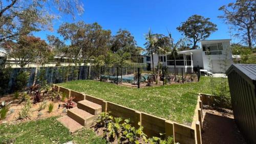 a house with a yard with a fence at The Bay Haus - Luxury Escape so close to the Beach in Worrowing Heights