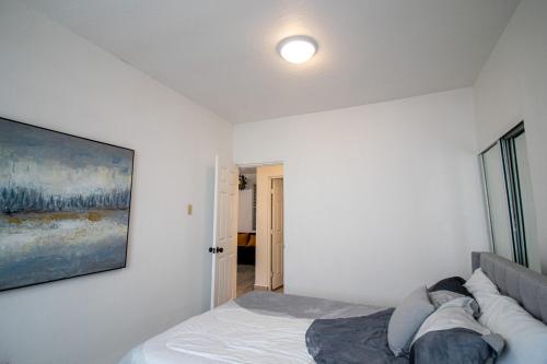 a bedroom with a bed with a painting on the wall at Entire Vacation Home in San Juan - Fits 10 in San Juan