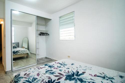 a bedroom with a bed and a mirror at Entire Vacation Home in San Juan - Fits 10 in San Juan