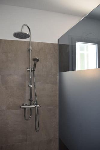 a shower with a shower head in a bathroom at Harmonia sur Moment-Ardeche-com in Rosières