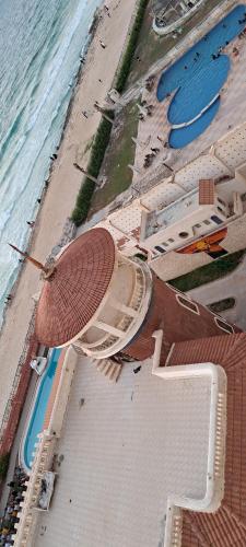 an aerial view of a beach with a pool and the ocean at Panorama Apartment with a charming sea view near Alexandria and Burg ElArab Airport with Free Wifi شقة باطلالة ساحرة على البحر اول الساحل الشمالي واي فاي مجاني迷人海景公寓 免费无线网络 in Alexandria