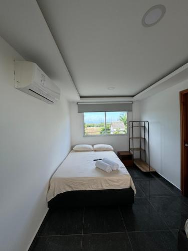 a bedroom with a bed and a window at Hotel La Yarolina SAS in Cartagena de Indias