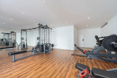 a gym with treadmills and weights in a room at New Penthouse in Medano with Jacuzzi and Terrace in Cabo San Lucas
