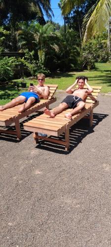 three men laying on picnic tables in a park at The Esence of Sri Lanka in Ahungalla