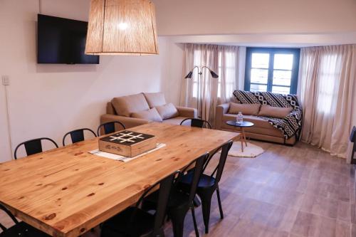 a living room with a wooden table and a couch at Casa de Campo Ana María in Tupungato
