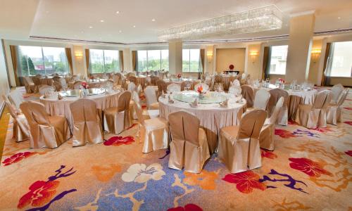 a banquet hall with white tables and chairs at Dorsett Shanghai in Shanghai
