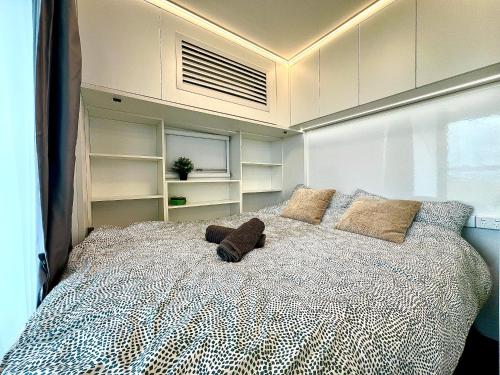 a bedroom with a large bed with pillows on it at Field Tiny Home - Fruit & Sunset in Hall