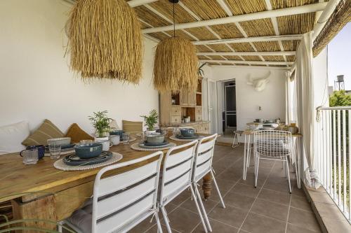 a dining room with a wooden table and chairs at Casa Jardin Competa in Cómpeta