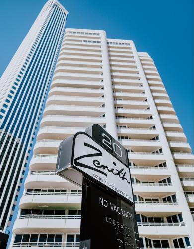 a no parking sign in front of a tall building at Zenith Apartments - Q Stay in Gold Coast