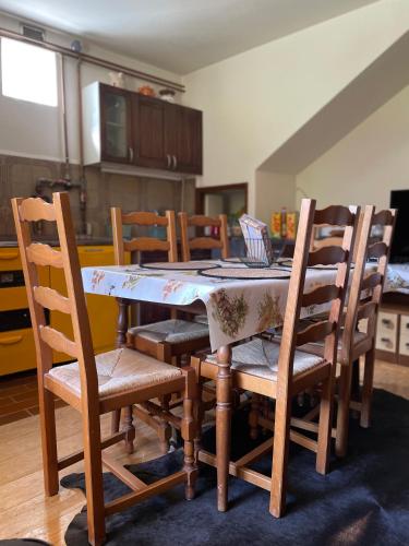 a dining room table with chairs and a table cloth at SanMari_forest in Ledenice
