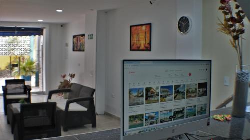 a computer monitor sitting in a living room at Hotel La Yarolina SAS in Cartagena de Indias
