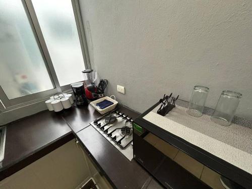 a kitchen with a stove and a counter top at Loft Sipeh Xalapa Departamento 4 in Xalapa