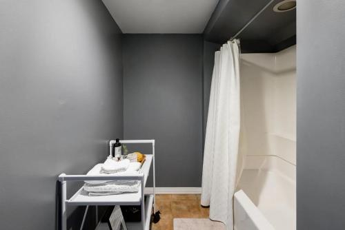 a bathroom with a shower curtain and a sink at Chic Spot near the Lower French Quarter in New Orleans