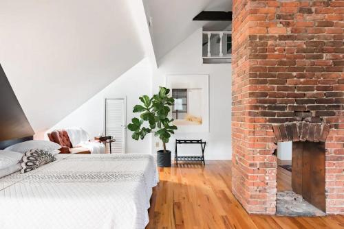 a living room with a brick fireplace and a bed at Chic Spot near the Lower French Quarter in New Orleans