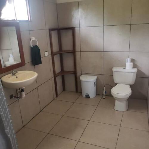 a small bathroom with a toilet and a sink at CañoNegro CasaBlanca in Caño Negro