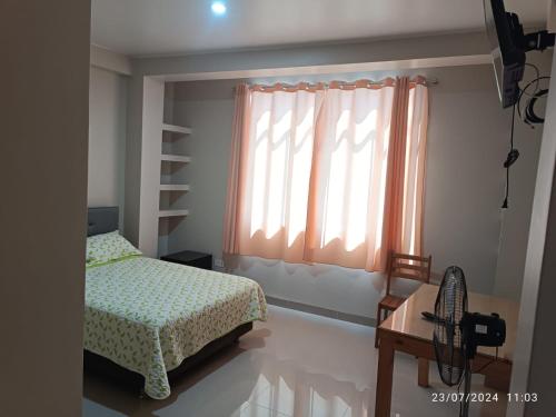 a bedroom with a bed and a window at Hospedaje Marfeb in Cieneguilla