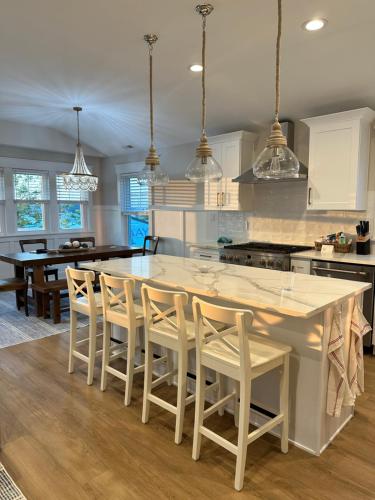 a kitchen with a large white table and chairs at Heart of Ocean City - WALK to shops, restaurants, boardwalk and beach! in Ocean City