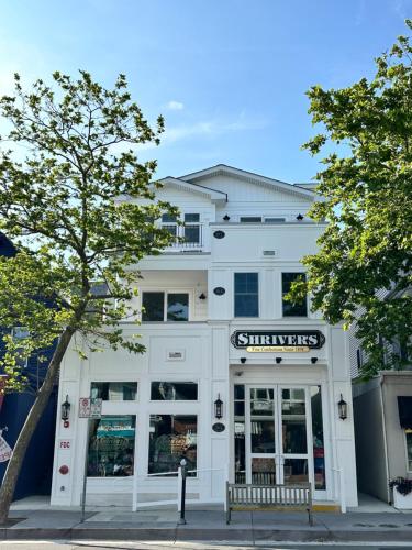 a white building with a sign in front of it at Heart of Ocean City - WALK to shops, restaurants, boardwalk and beach! in Ocean City