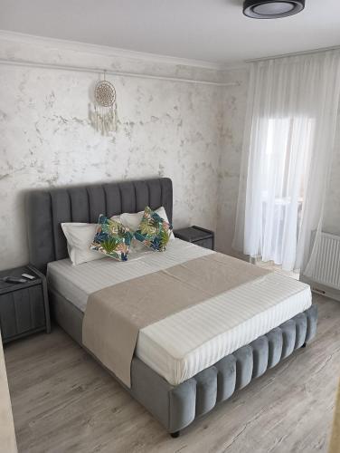 a bedroom with a large bed with two pillows at Casa mea in Bucharest