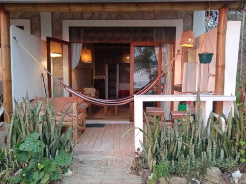 a house with a hammock in front of it at Punto Verde Ecological house in Montañita