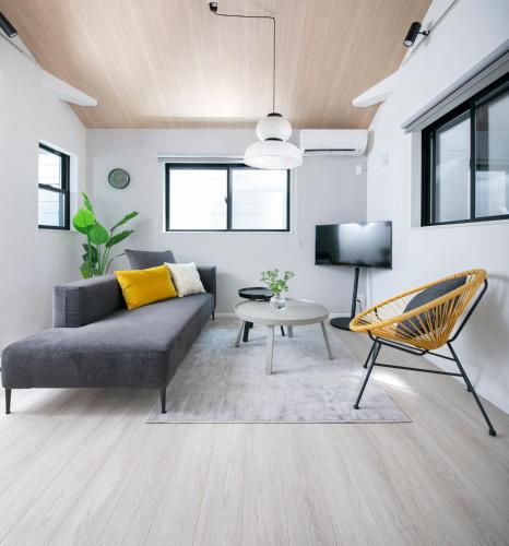 a living room with a couch and a table at pufuka Higashi Mukojima 4 in Tokyo
