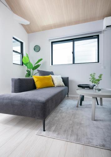 a living room with a couch and a table at pufuka Higashi Mukojima 4 in Tokyo