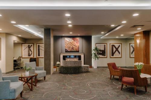 a lobby with a waiting area with chairs and a fireplace at Club Quarters Hotel Embarcadero, San Francisco in San Francisco