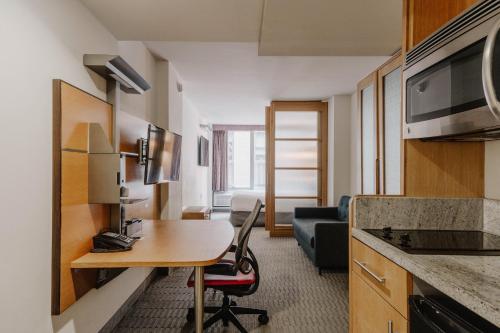 a room with a kitchen and a desk in a room at The Jewel Hotel, New York in New York