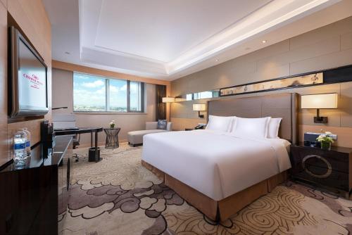 a hotel room with a large bed and a desk at Crowne Plaza Xi'an by IHG in Xi'an