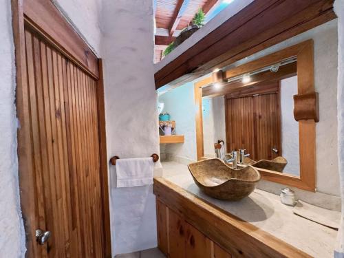 a bathroom with a wooden sink and a mirror at Casa el mirador-Valle de Bravo in Colorines