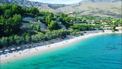 an aerial view of a beach with people on it at Summer Park Residence Peljesac in Orebić
