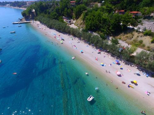 an aerial view of a beach with people in the water at Summer Park Residence Peljesac in Orebić