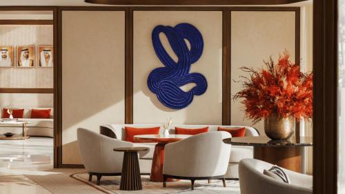 a lobby with a table and chairs and a painting at Jumeirah Residences Marsa Al Arab Dubai in Dubai