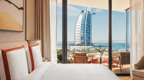 a bedroom with a bed and a view of a building at Jumeirah Residences Marsa Al Arab Dubai in Dubai