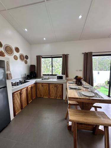 a kitchen with a wooden table and a counter top at Rvilla El Nido in El Nido