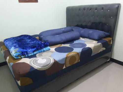 a bed with two pillows on top of it at Dhea Homestay Bromo in Probolinggo