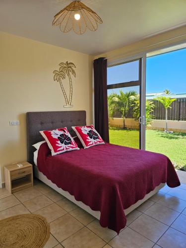 a bedroom with a bed and a large window at Cozy House in a private complex in Paea