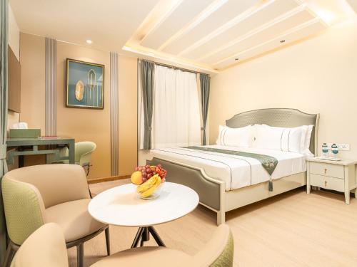 a hotel room with a bed and a table and chairs at Eternity By Greenscape in Srinagar
