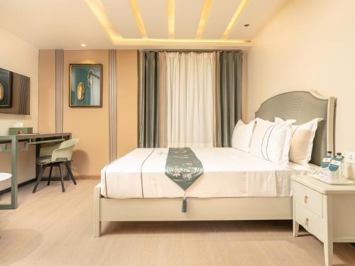a hotel room with a bed and a desk at Eternity By Greenscape in Srinagar