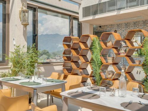 a restaurant with tables and chairs and a large window at Eternity By Greenscape in Srinagar