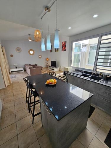a kitchen with a island in the middle of a room at Cozy House in a private complex in Paea