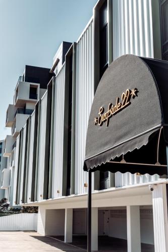 a building with a sign on the front of it at Surfside 22 in Wollongong