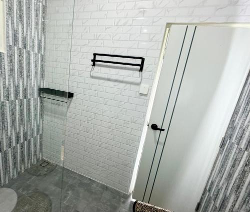 a shower with a glass door in a bathroom at SwanBB in Hang Dong