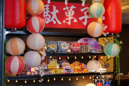 a shelf filled with paper lanterns and a sign at Kuromon Crystal Hotel in Osaka