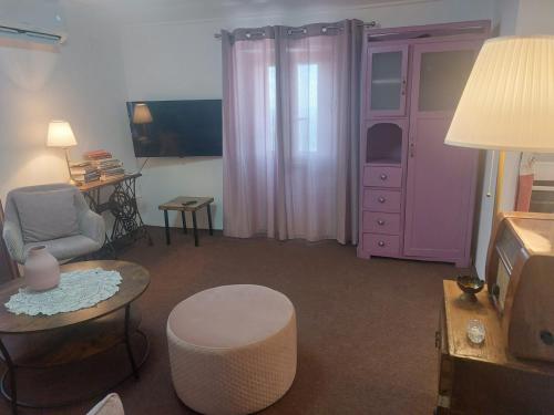 a living room with a couch and a chair and a table at Apartment Dunja with Panoramic View in Grožnjan