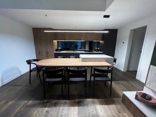 a kitchen with a table and chairs in a room at Mt Buller Chalet Hotel & Suites in Mount Buller