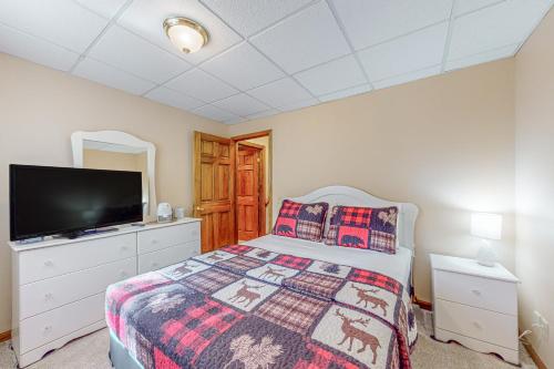 a bedroom with a bed and a flat screen tv at Tall Pines in Woodruff