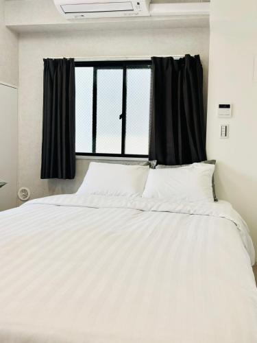 Katil atau katil-katil dalam bilik di GLOU Shinjuku Family - Urban Stay in Tokyo Shinjuku Area, Walking distance of Kabukicho